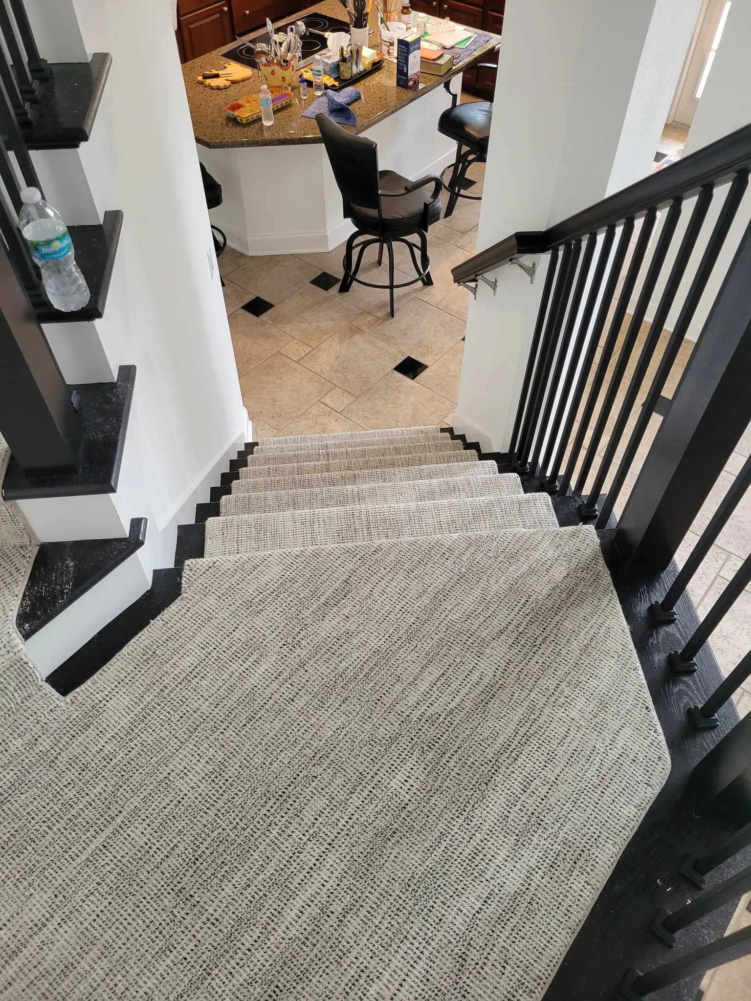 Custom stair runner fitted over dark wood treads