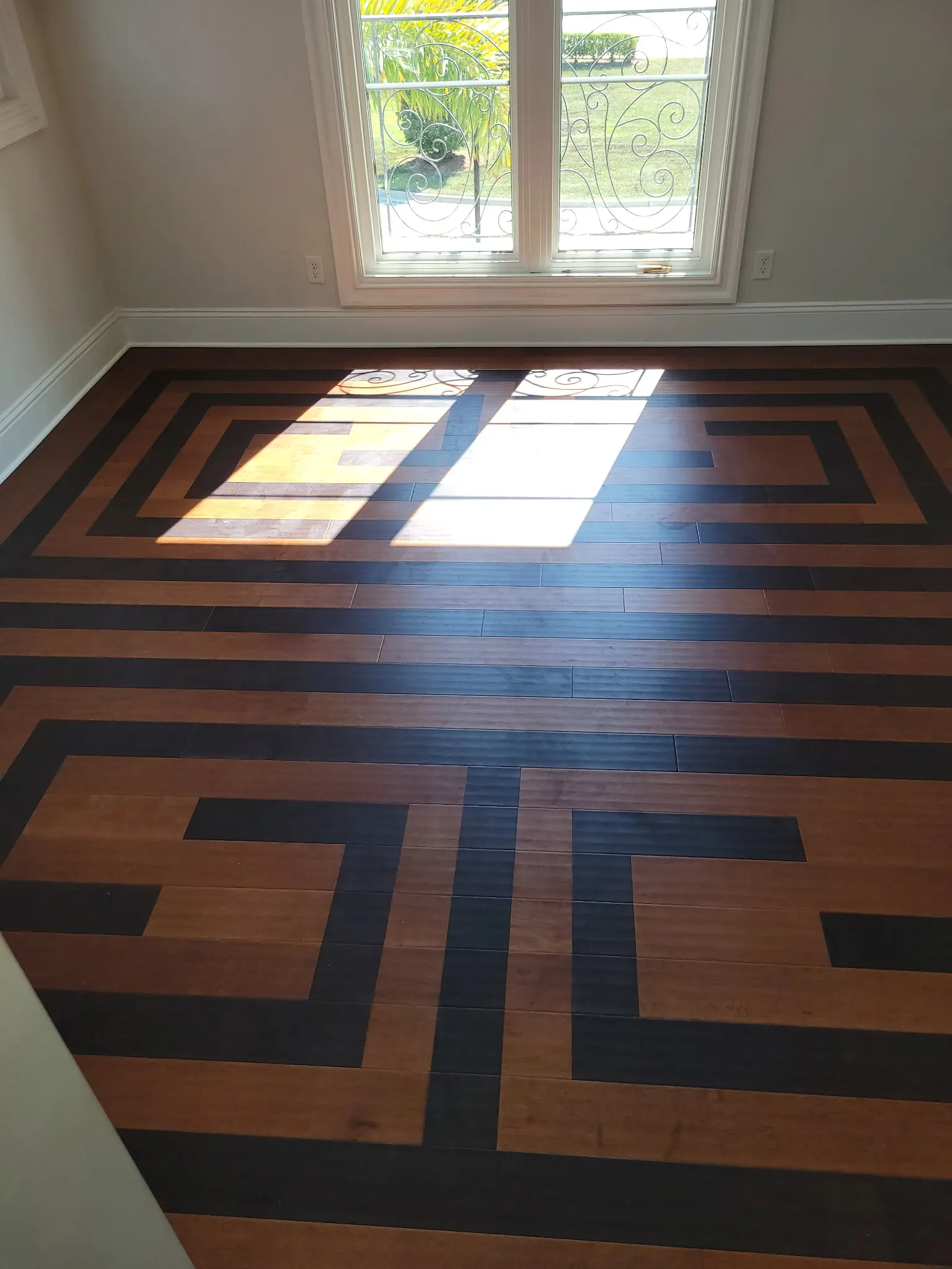 Custom two-tone geometric wood floor completed by Shullin Boodoo Carpet Inc.